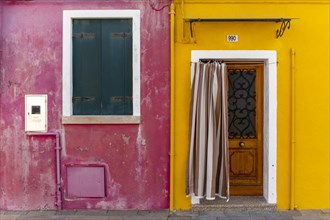 Door and window of a yellow and pink house