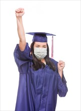 Graduating female wearing medical face mask and cap and gown cheering isolated on a white background