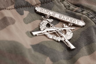 Rifle expert war medal on a camouflage material