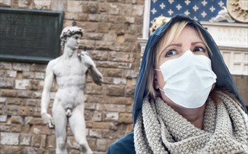 Young Woman Wearing Face Mask Walks Near the Statue of David in the Piazza della Signoria