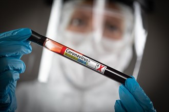Female Lab Worker Holds Test Tube of Blood Labeled Coronavirus COVID-19 Disease