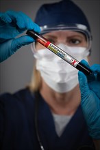 Female Lab Worker Holds Test Tube of Blood Labeled Coronavirus COVID-19 Disease