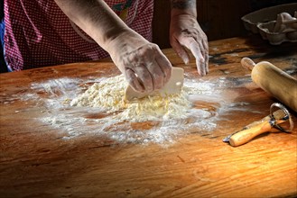 Woman mixes fresh pasta dough