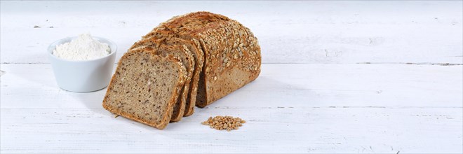 Bread multigrain bread wholemeal bread grain bread cut slice banner text free space on wooden plate