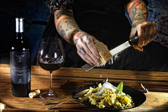 Woman with tattooed hands and fresh pasta