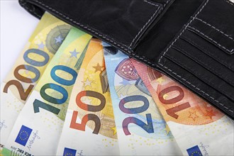 Various euro banknotes in black leather wallet