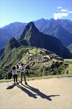 Two tourists wearing T-shirts with Love on them in the ruined city of the Incas
