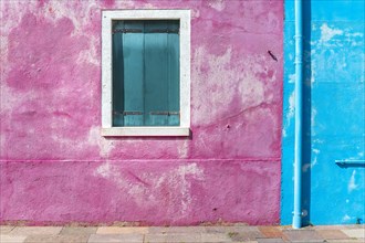 Window of a blue and pink house