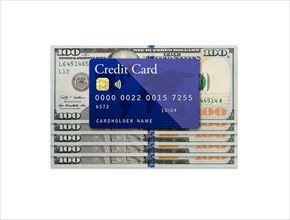Mockup blue credit card resting on one hundred dollar bills on white background