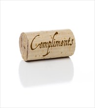 Compliments branded wine cork isolated on a white background