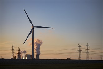 Wind turbine and lignite power plant at sunset