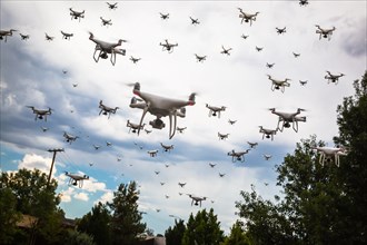 Dozens of drones swarm in the cloudy sky