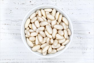 White beans raw from above wooden board