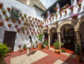 Young woman standing in a courtyard decorated with flowers