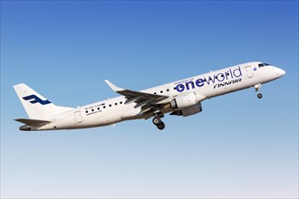 A Finnair Embraer 190 aircraft with the registration OH-LKN in the OneWorld special livery takes off from Helsinki Airport