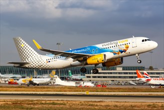 A Vueling Airbus A320 with the registration EC-MLE and the special livery 25 years Disneyland Paris takes off from Palma de Majorca Airport