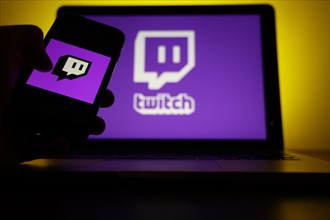 Logo of the streaming platform twitch for gamers on a laptop and a smartphone