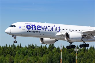A Finnair Airbus A350-900 with the registration OH-LWB in the OneWorld special livery lands at Helsinki Airport