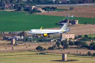 A Vueling Airbus A320 with the registration EC-MKM lands at the airport of Palma de Majorca