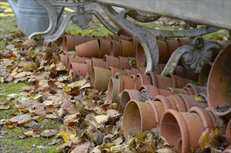 Terracotta flowerpots stored under garden seat