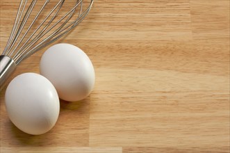 Mixer and eggs on a wooden background