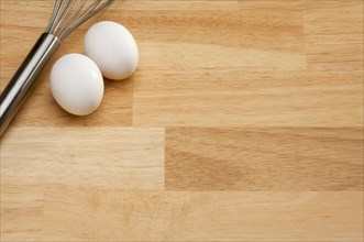 Mixer and eggs on a wooden background