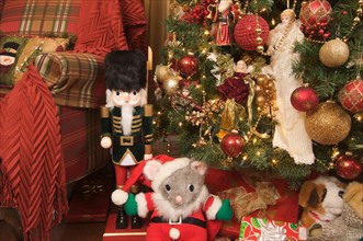 Nutcracker and christmas decorations around the tree