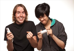 Fun happy mixed-race couple playing video game remotes isolated on a white background