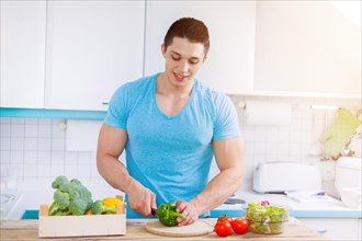 Preparing food vegetable cutting young man lunch kitchen healthy nutrition text free space copyspace in germany
