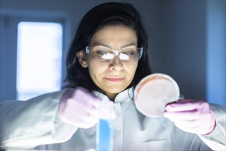 Middle aged technician in laboratory with lab coat