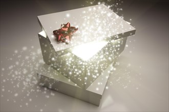 Stack of christmas presents with magical sparkling light coming from inside
