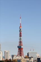 Cityscape with Tokyo Tower in front of blue sky
