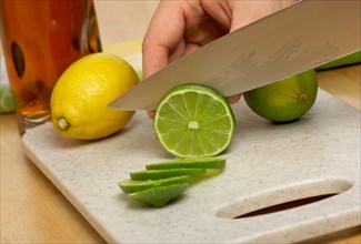 Slicing a lime on a cutting board