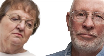 Melancholy senior couple isolated on a white background