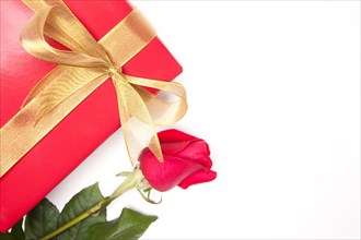 Gift with gold ribbon and rose isolated on a white background