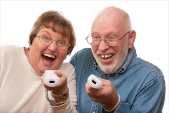 Happy senior couple play video game with remote controls