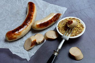 Sliced bratwurst and skin with Dijon mustard