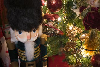 Nutcracker and christmas decorations around the tree