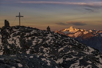 Sunrise over summit of the Oetztaler Wildspitze with summit cross of the high Nebelkogel
