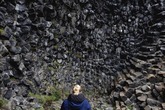 Woman in front of column basalt