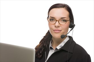 Helpful mixed-race receptionist in front of computer wearing phone head-set isolated on white background
