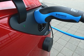 Charging port with charging cable on car Tesla Model 3