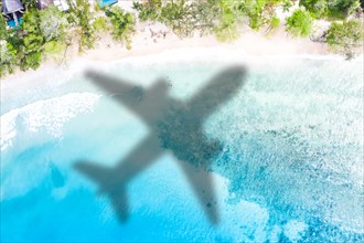 Travel symbolic image holiday sea airplane fly island aerial picture beach air travel on the Seychelles