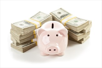 Pink piggy bank with stacks of hundreds of dollars isolated on a white background