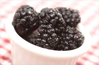 Blackberries in a small bowl with narrow depth of field