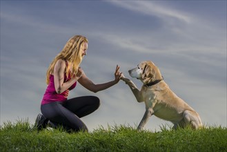 Young woman playing with dog