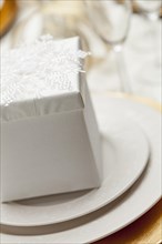 Beautiful christmas gift with place setting abstract at table