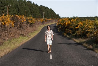 Guy walking on a road