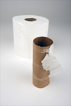 Abstract conceptual empty and full toilette paper rolls