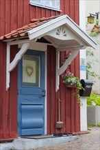 Traditional blue front door in red Swedish house Wooden house in Vimmerby